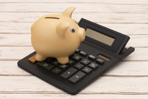 The Importance of Budgeting in Addiction Recovery - piggy bank on a calculator