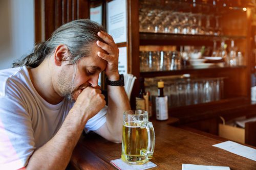 middle age man at bar feeling ill