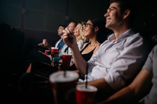 group of friends watching a movie in the theater - weekend