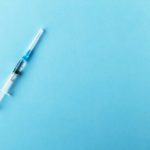 syringe on blue background - IV