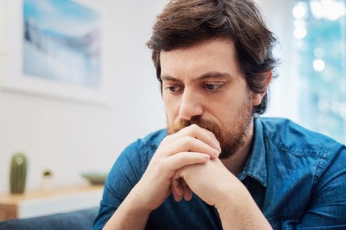 pensive or concerned man in blue shirt - seek treatment