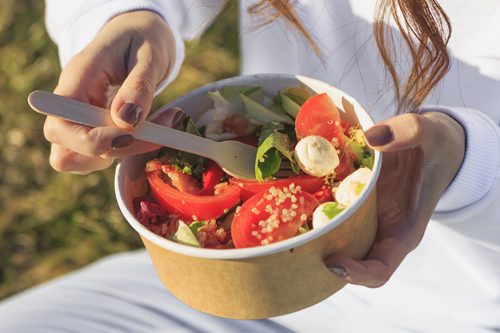 closeup of woman eating a salad outdoors - anxiety and depression