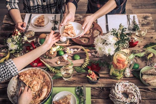 aerial shot of holiday feast being enjoyed by friends - gratitude