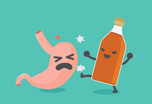 cartoonish drawing of bottle of alcohol kicking a stomach - effects of alcohol on the body