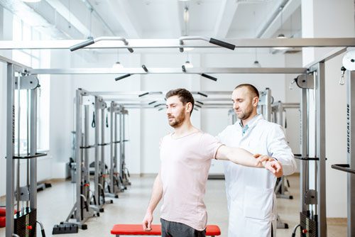 man at physical therapy - chronic pain